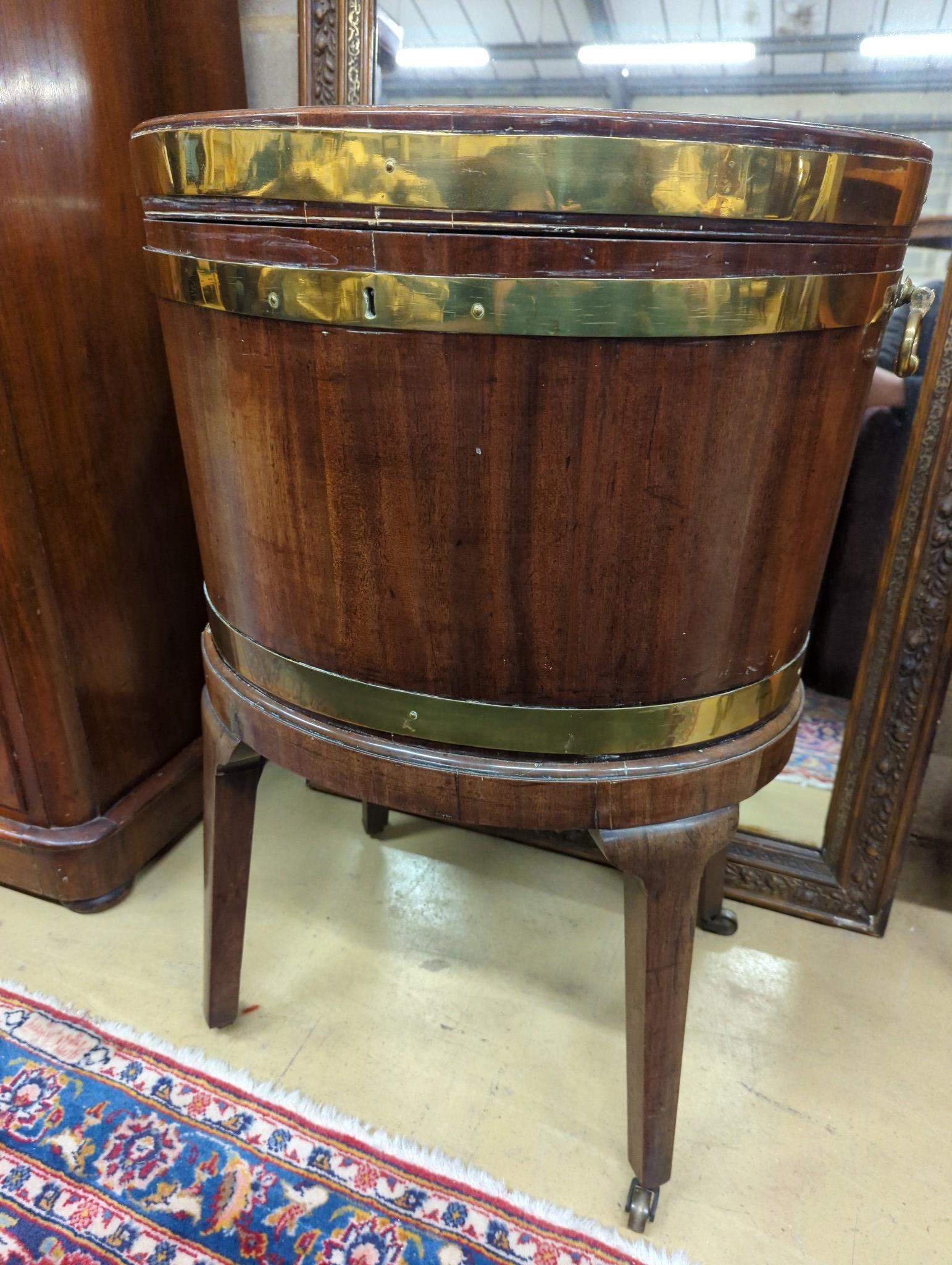 A George III mahogany triple brass bound oval wine cooler on stand, width 56cm, depth 43cm, height 78cm